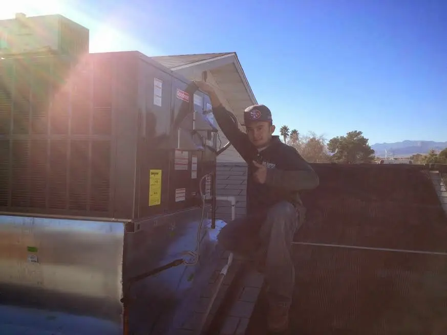 HVAC technician performing HVAC Inspection on a rooftop unit in Deer Park